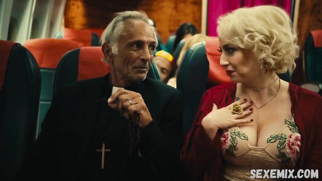 Jin N Tonic shows us her beautiful cleavage, scene in Exorcism At 60,000 Feet